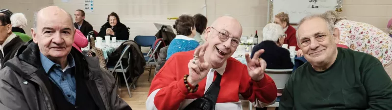 Three older men at the Abbey Christmas event