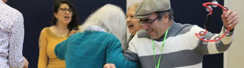 Two members dancing at a Kilburn Good Neighbours event