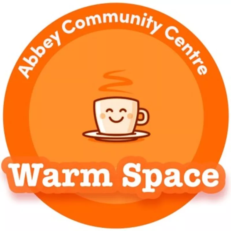 Warm space logo in orange with smiling teacup